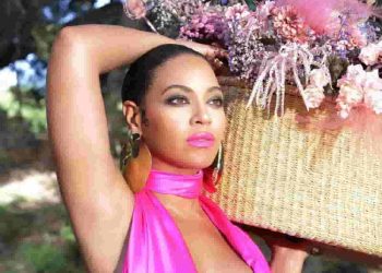 beyonce - a woman carrying a flower basket