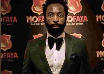 mofaya soft drinks - a black man in a tuxedo