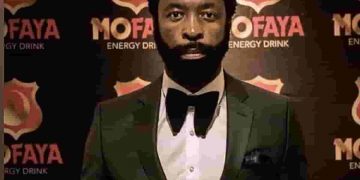 mofaya soft drinks - a black man in a tuxedo