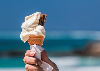 a woman holding an ice cream cone sugar