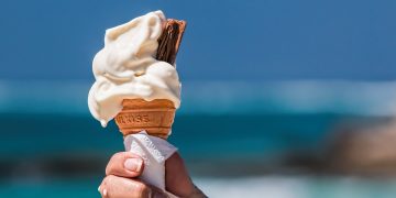 a woman holding an ice cream cone sugar