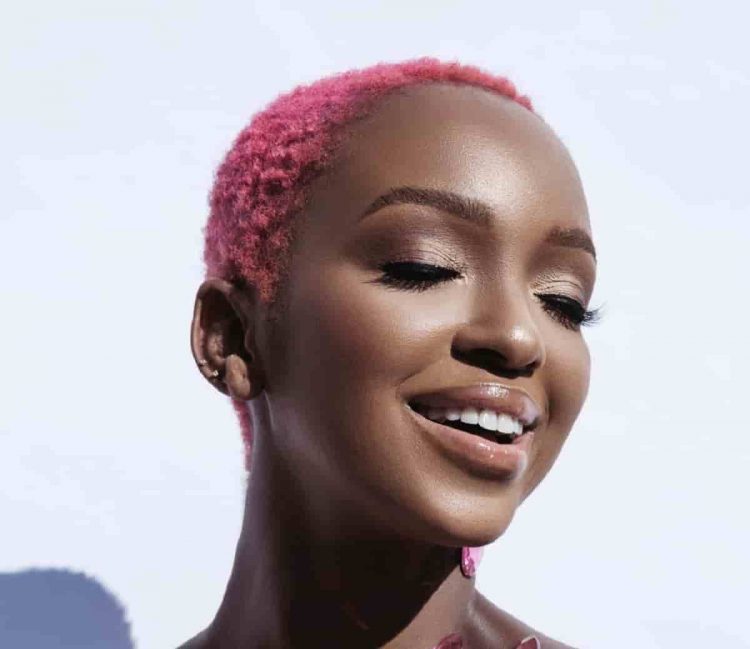 nandi madida - a black woman with short hair dyed pink