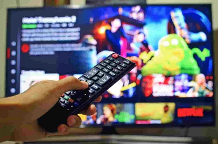 netflix showmax amazon prime new movies - hand pressing a remote control