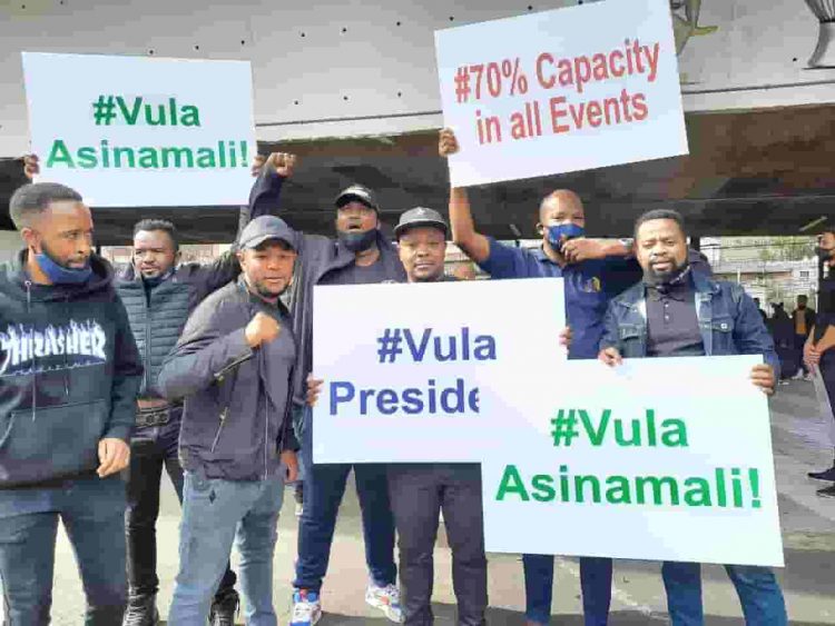 vula president - a group of protesters holding placards